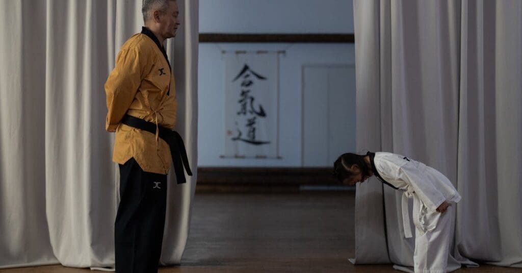 Child bowing to instructor during martial arts etiquette lesson