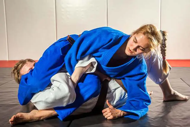 Grapplers maintaining control on the mat while learning BJJ safety tips