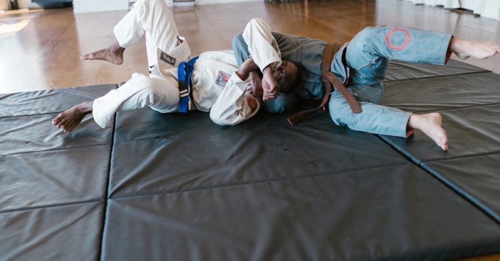Training partners practicing a choke defense during jiu jitsu terminology review
