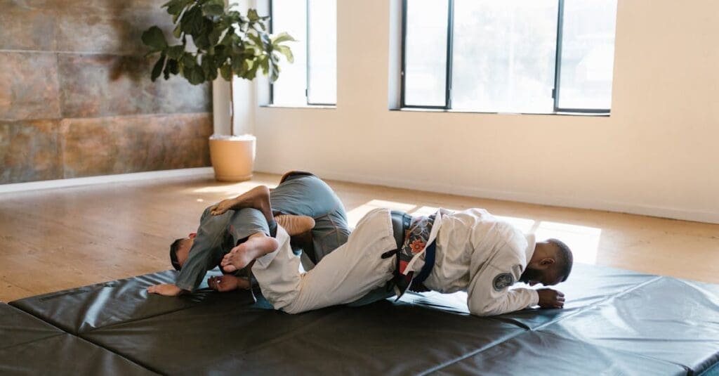 Grapplers working from guard during mat practice for BJJ training basics