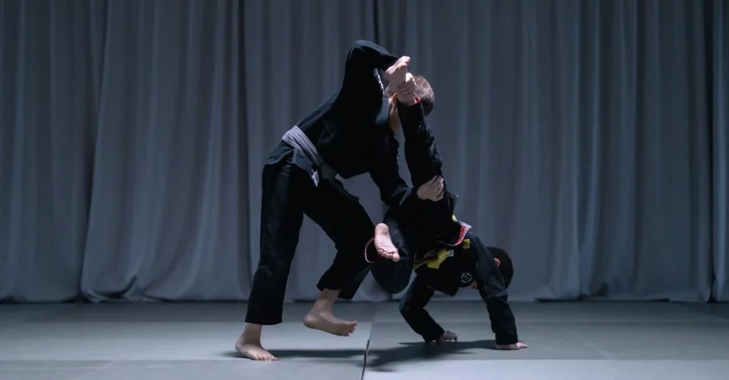 Students practicing a takedown during training for beginner BJJ techniques