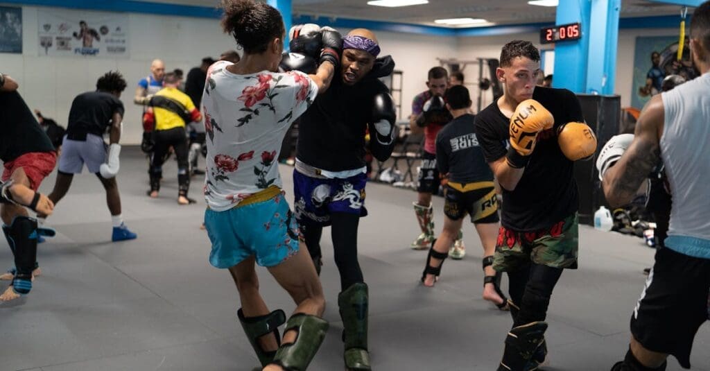 Partners practice light sparring drills focused on kickboxing safety