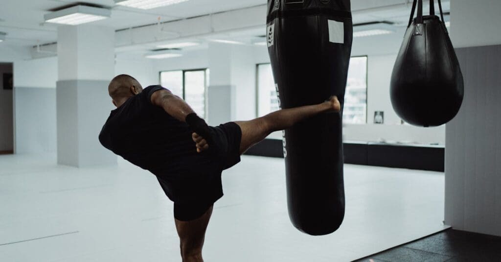 Student practices controlled heavy bag kick using kickboxing techniques