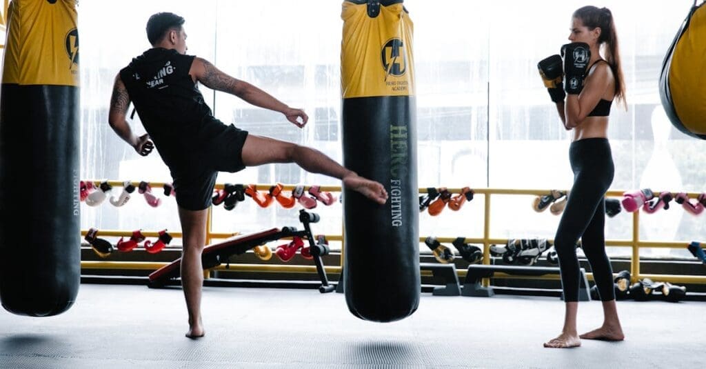 Trainer demonstrates side kick technique during beginner kickboxing practice