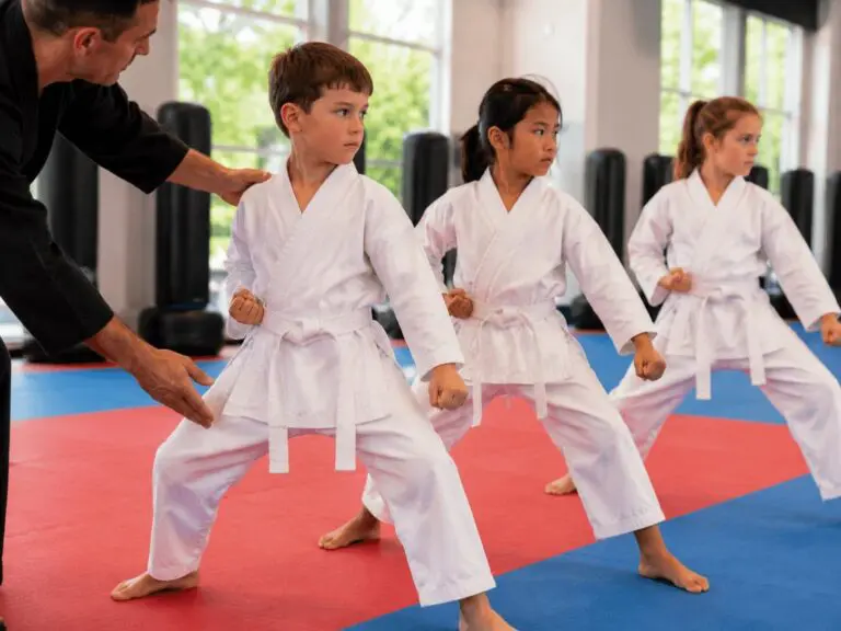 Instructor demonstrating basic stance to students in martial arts for beginners class